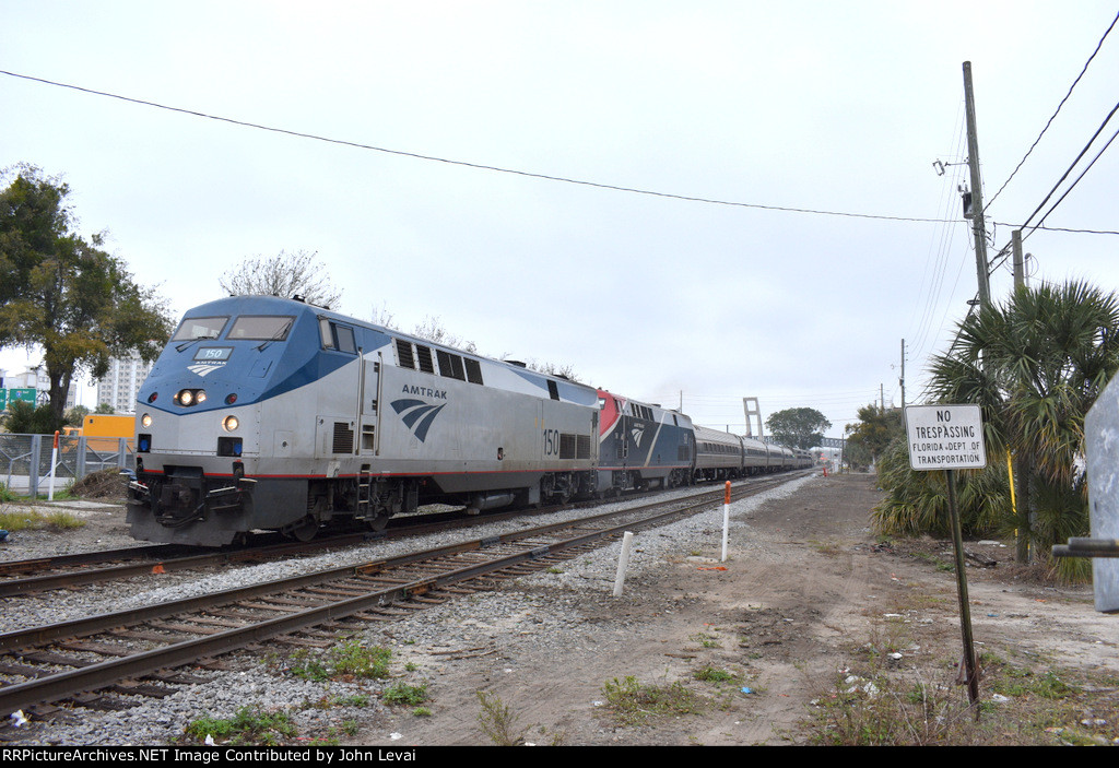 A late running Amtrak Floridian Train # 41 is about to pass the Sunrail LYNX Central Station with P42DCs # 150 and 138 as power